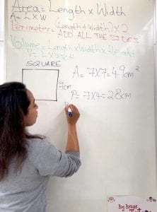 Rupal teaching at her whiteboard