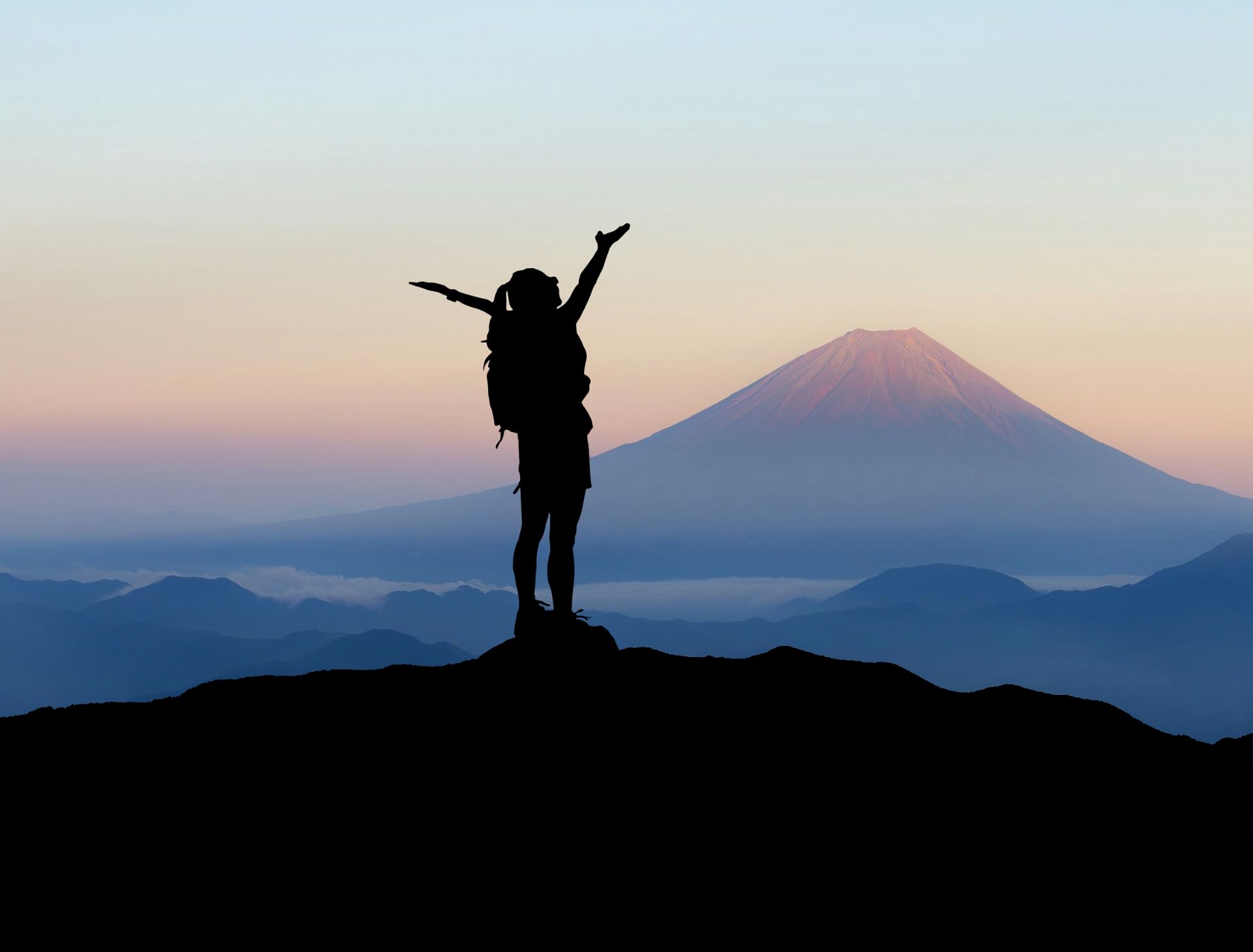 silhouette of backpacker on top of a mountain
