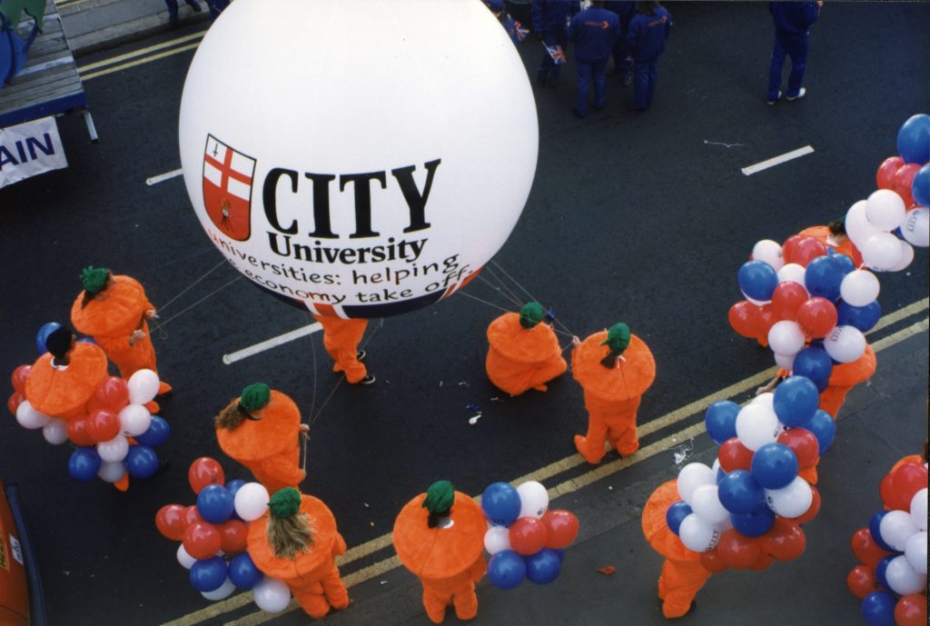 Lord Mayor's Show arial shot students with huge City University balloon dressed as carrots