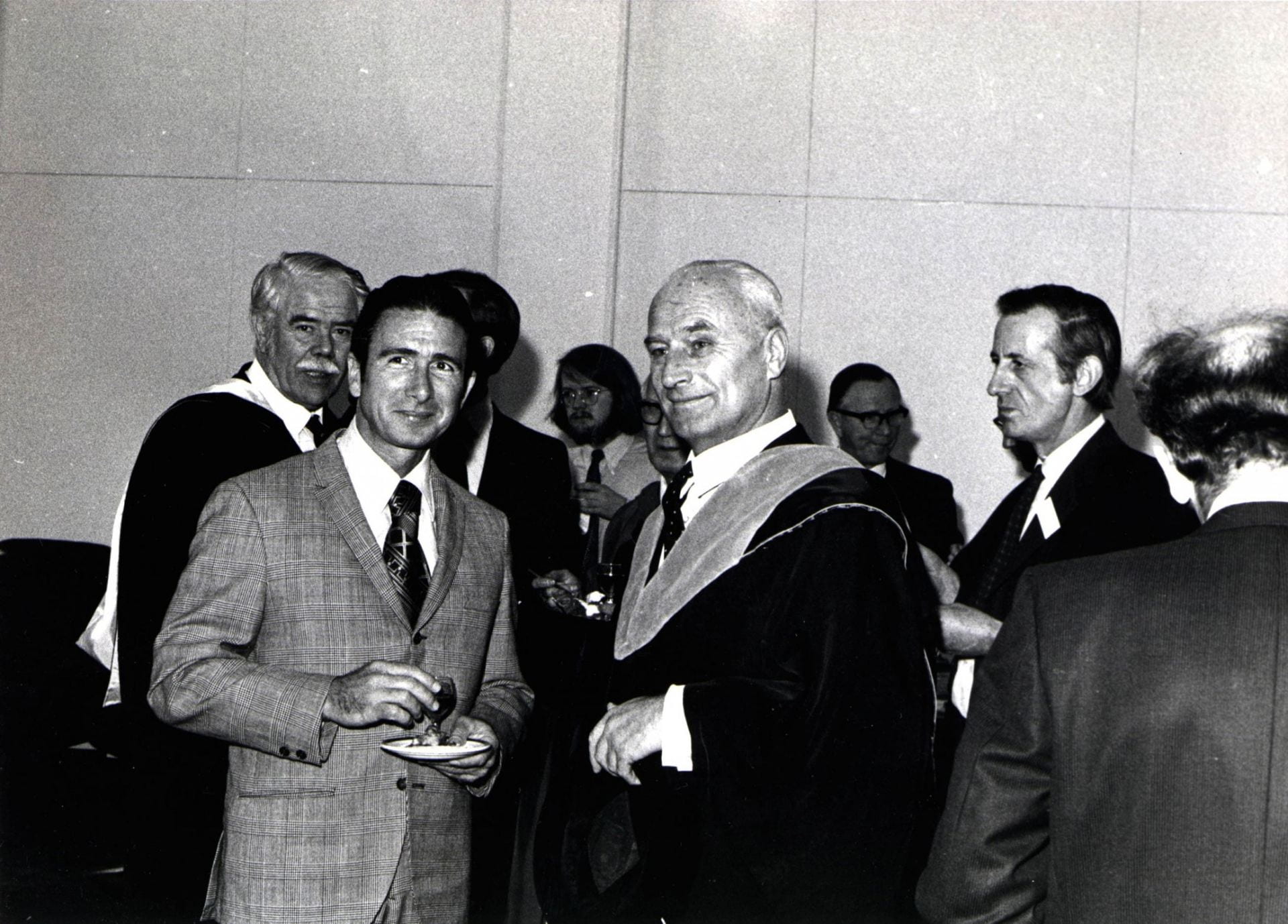 Colonel James Irwin (centre left) and Professor Grigory Tokaty (centre right) and at the reception for the Apollo 15 astronauts at City in 1971. Various other figures stand behind the two men.
