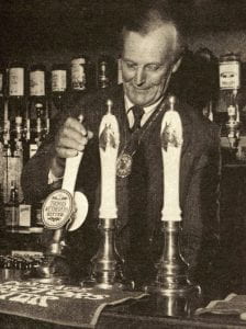 Alan Loader Maffey, 2nd Baron Rugby, Master of the Saddlers Company, pulling the first pint in the new Saddlers' Bar, 1978. The pump handles feature horse's heads, in honour of the Saddlers. Source: City News (30 Oct 1978)