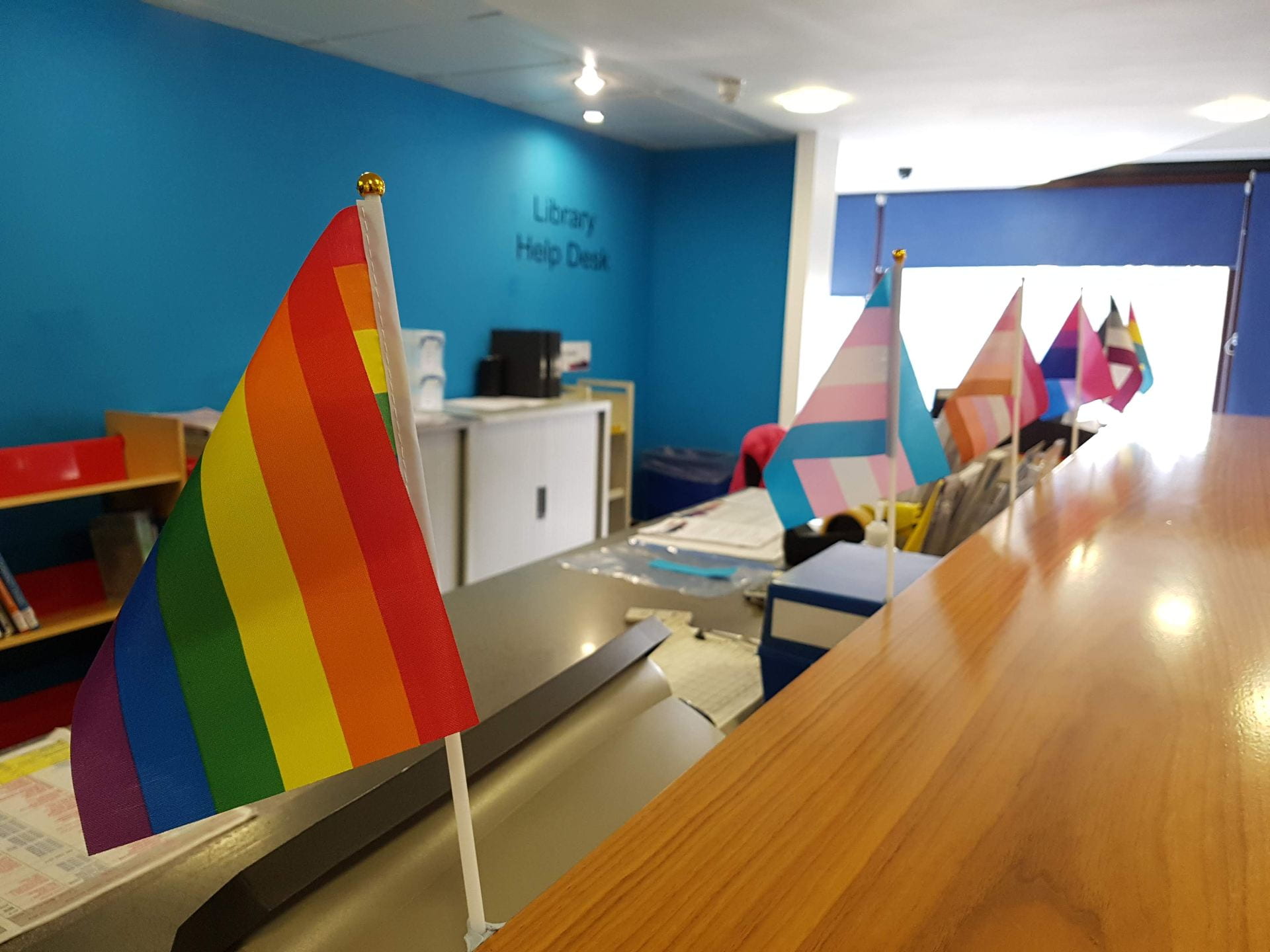 A picture of LGBT flags on Library Help desk
