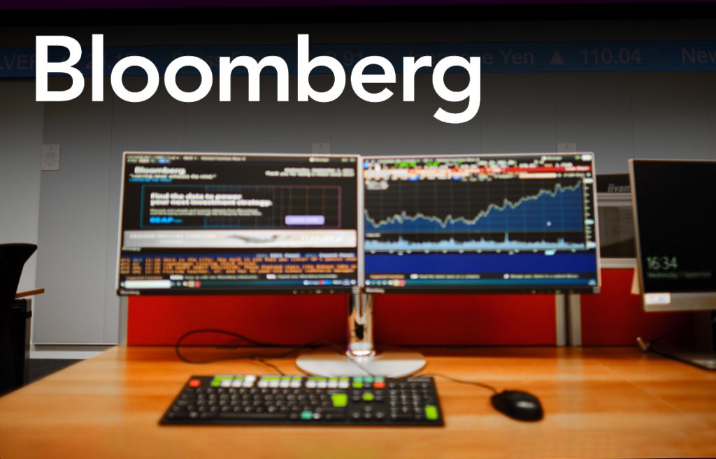 A Bloomberg terminal and the Bloomberg logo