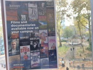 A poster for Kanopy streaming service with film posters showing films and documentaries available for students. The poster suggests to watch now at kanopy.com